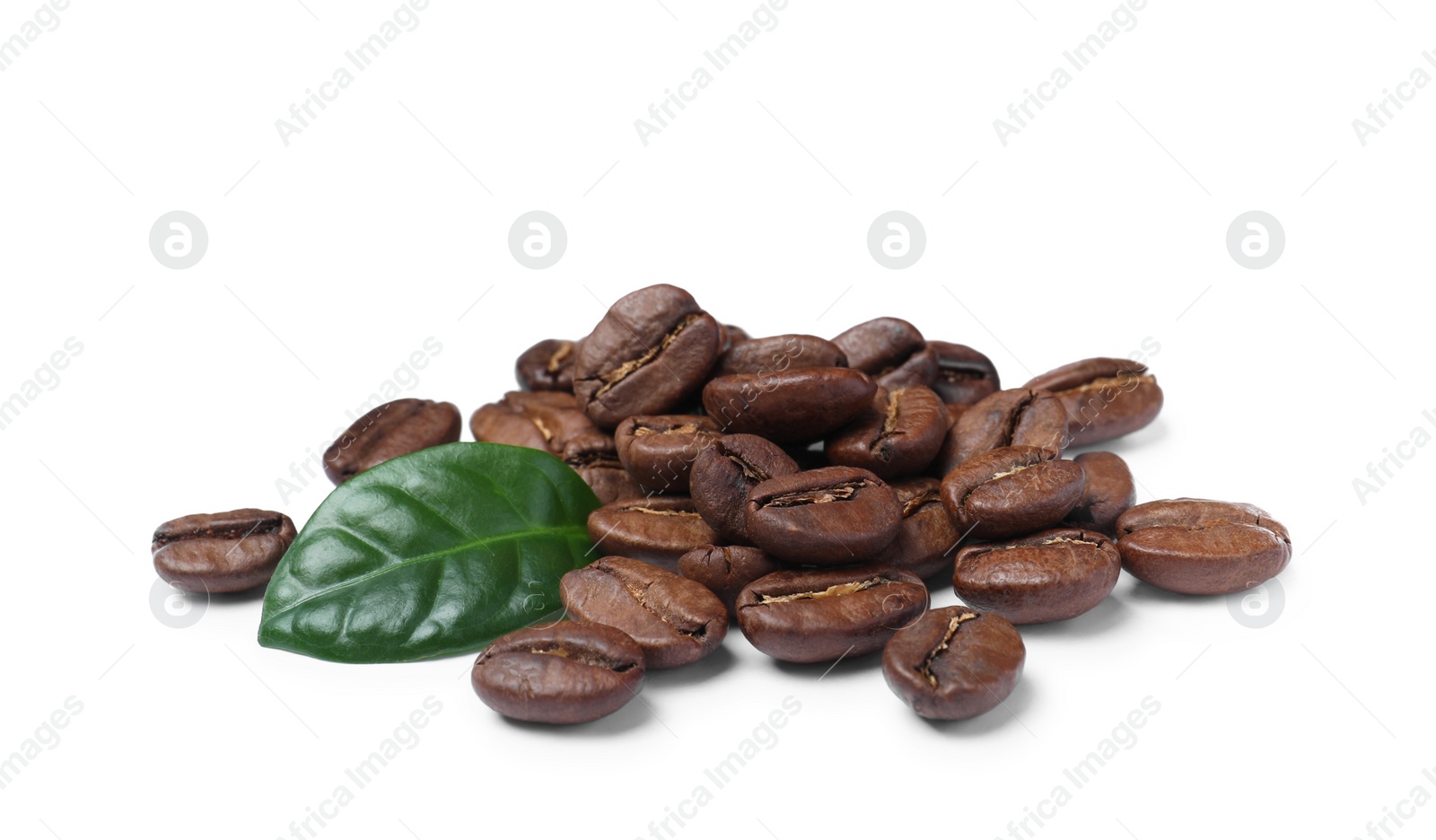 Photo of Pile of roasted coffee beans with fresh leaf on white background