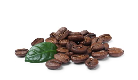 Photo of Pile of roasted coffee beans with fresh leaf on white background
