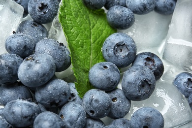 Juicy and fresh blueberries with and ice, closeup