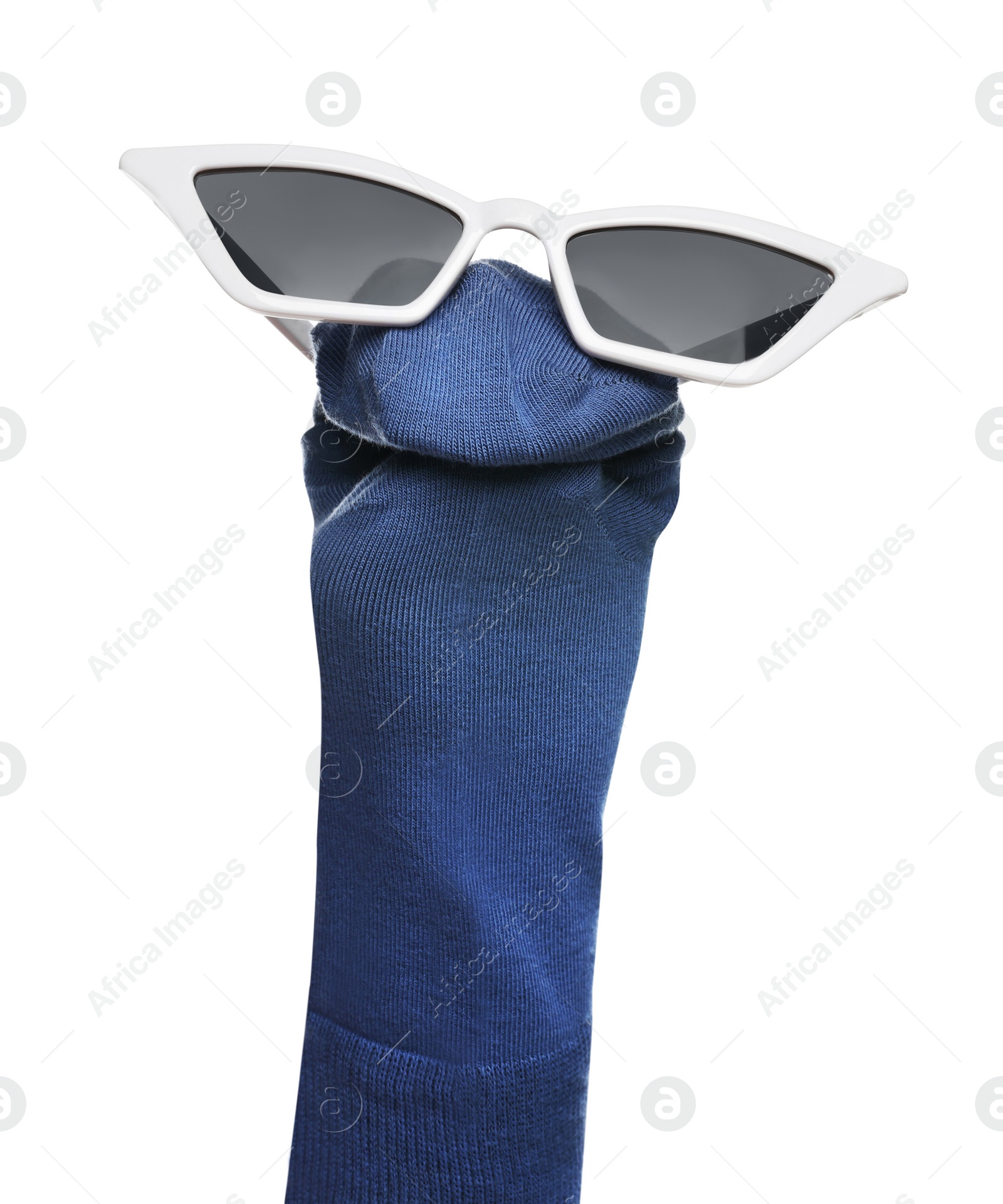 Photo of Funny sock puppet with sunglasses isolated on white