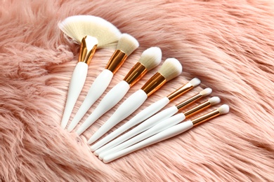Set of makeup brushes on faux fur