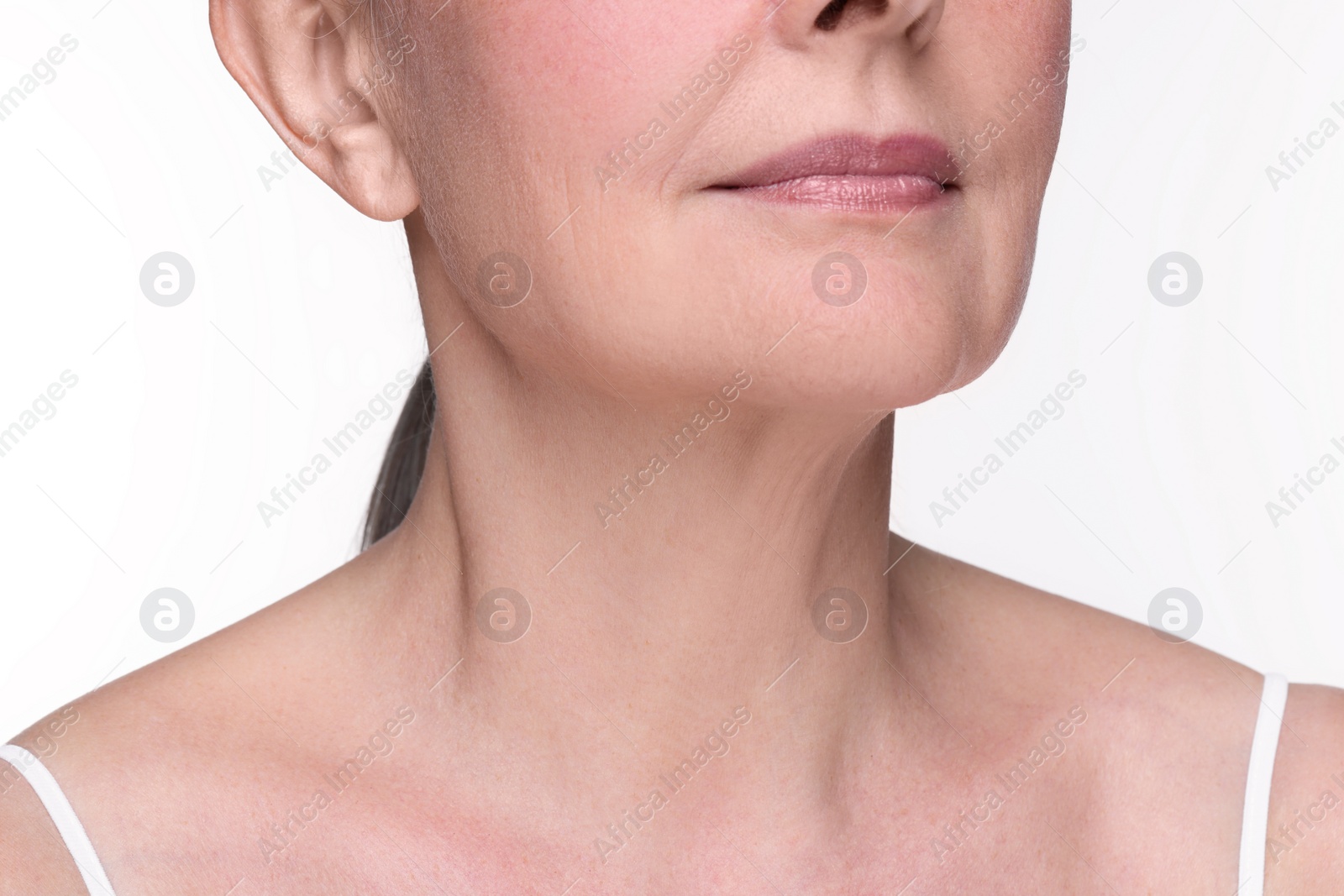 Photo of Senior woman with aging skin on white background, closeup. Rejuvenation treatment