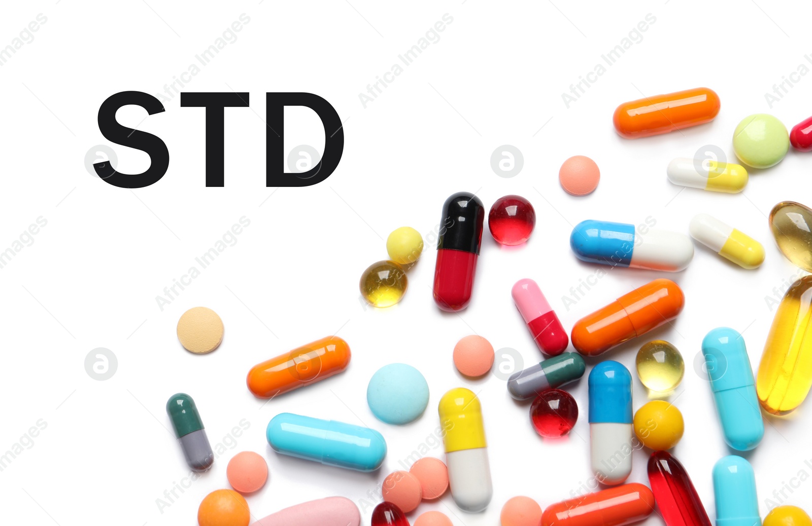 Image of Different pills and abbreviation STD on white background, top view