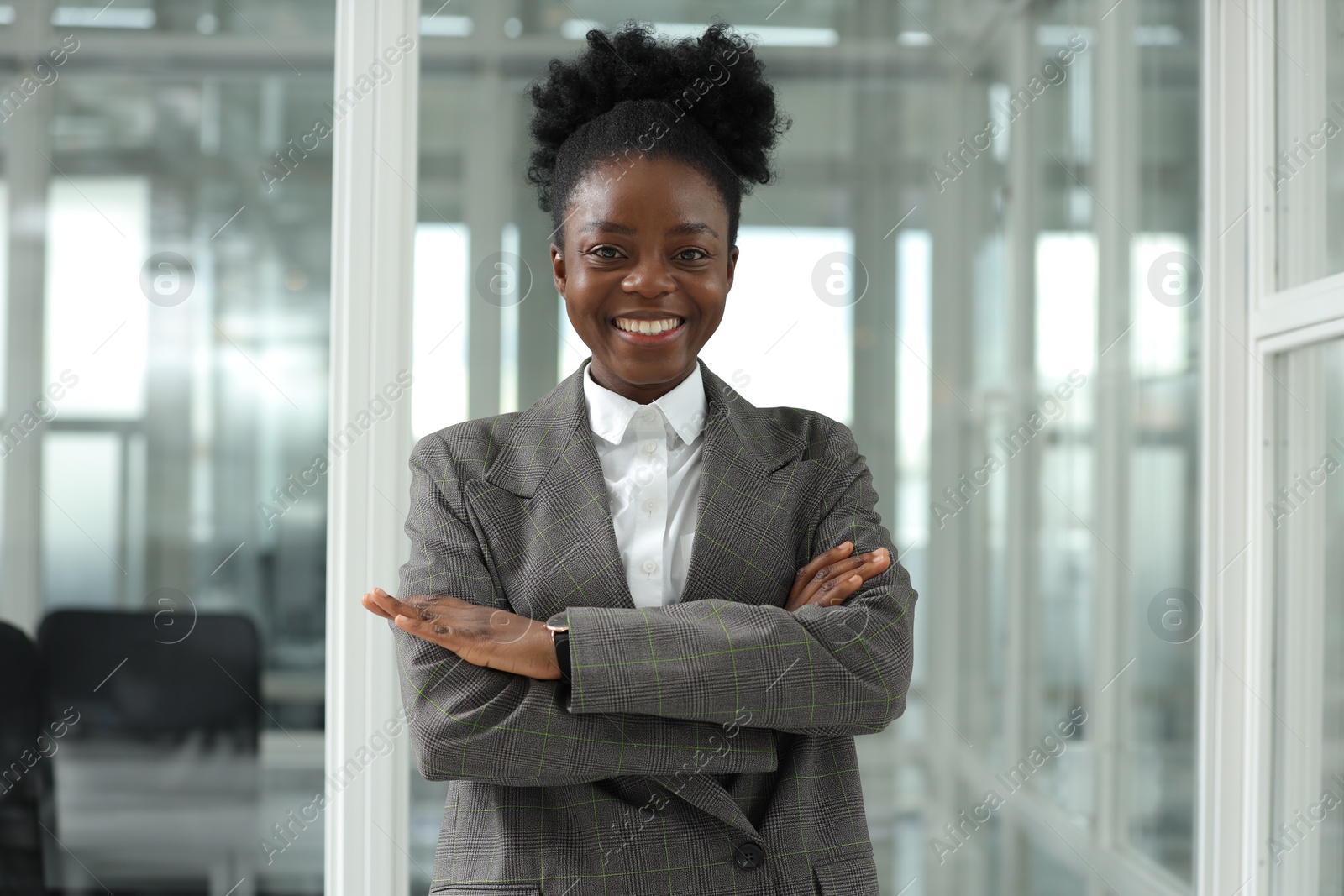 Photo of Happy woman with crossed arms in office. Lawyer, businesswoman, accountant or manager