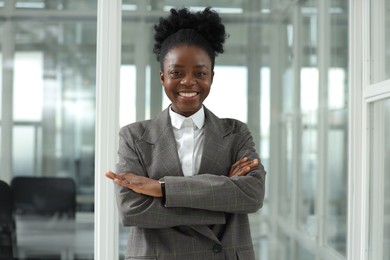 Happy woman with crossed arms in office. Lawyer, businesswoman, accountant or manager
