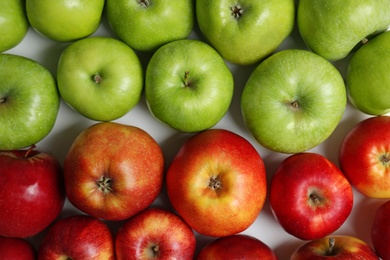 Fresh green and red apples as background