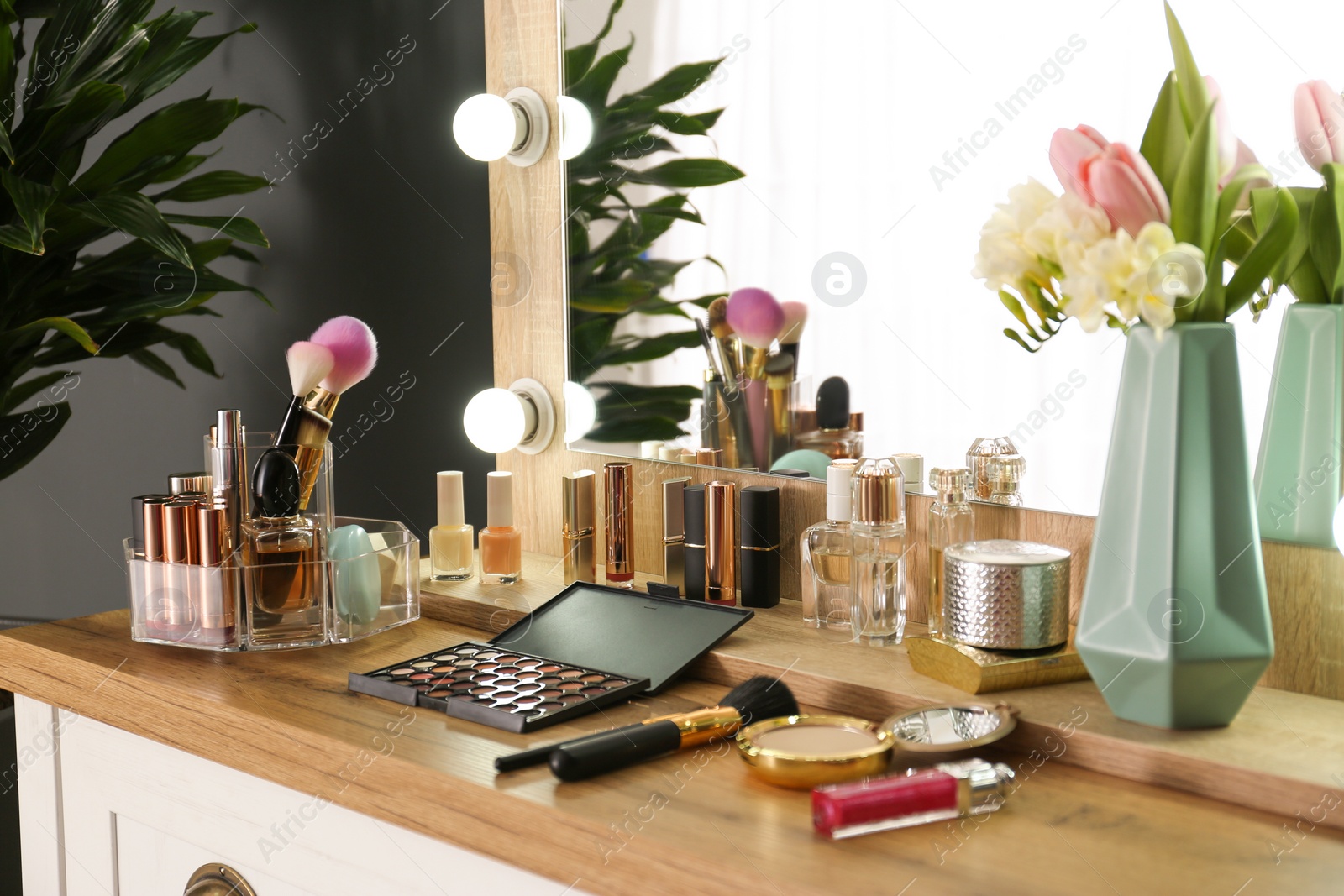 Photo of Dressing table with set of luxury cosmetic products. Interior element