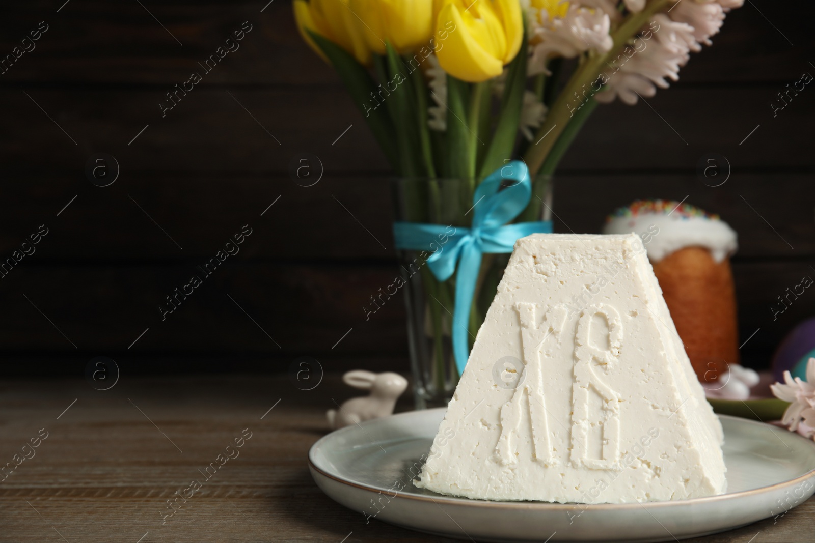 Photo of Traditional cottage cheese Easter paskha on wooden table, space for text