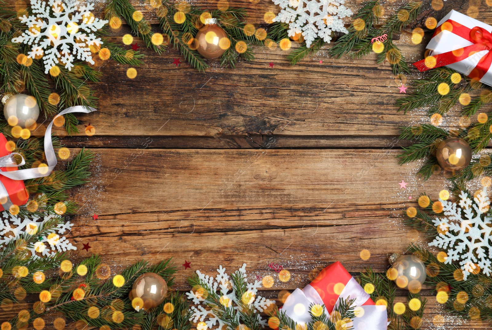 Photo of Christmas greeting card with space for text. Flat lay composition of fir tree branches and festive decor on wooden background