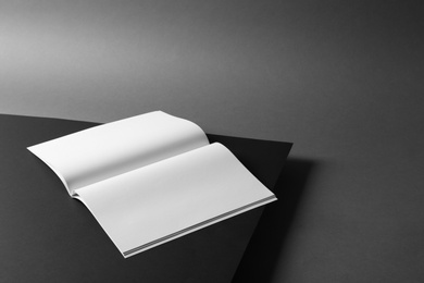 Photo of Empty book pages on dark background. Mockup for design