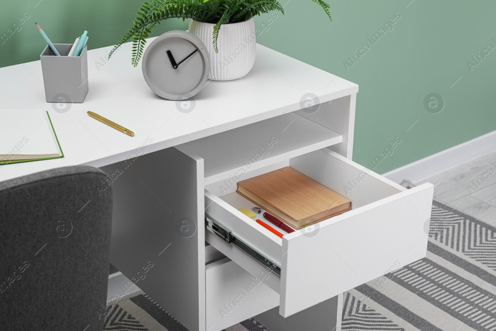 Photo of Office supplies in open desk drawer indoors