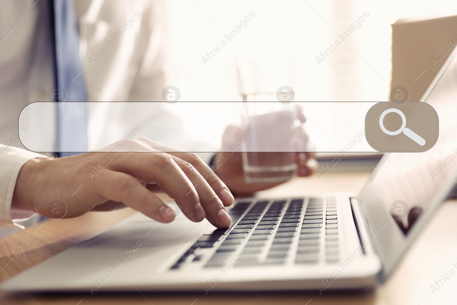 Image of Search bar of internet browser and man working with laptop in office, closeup