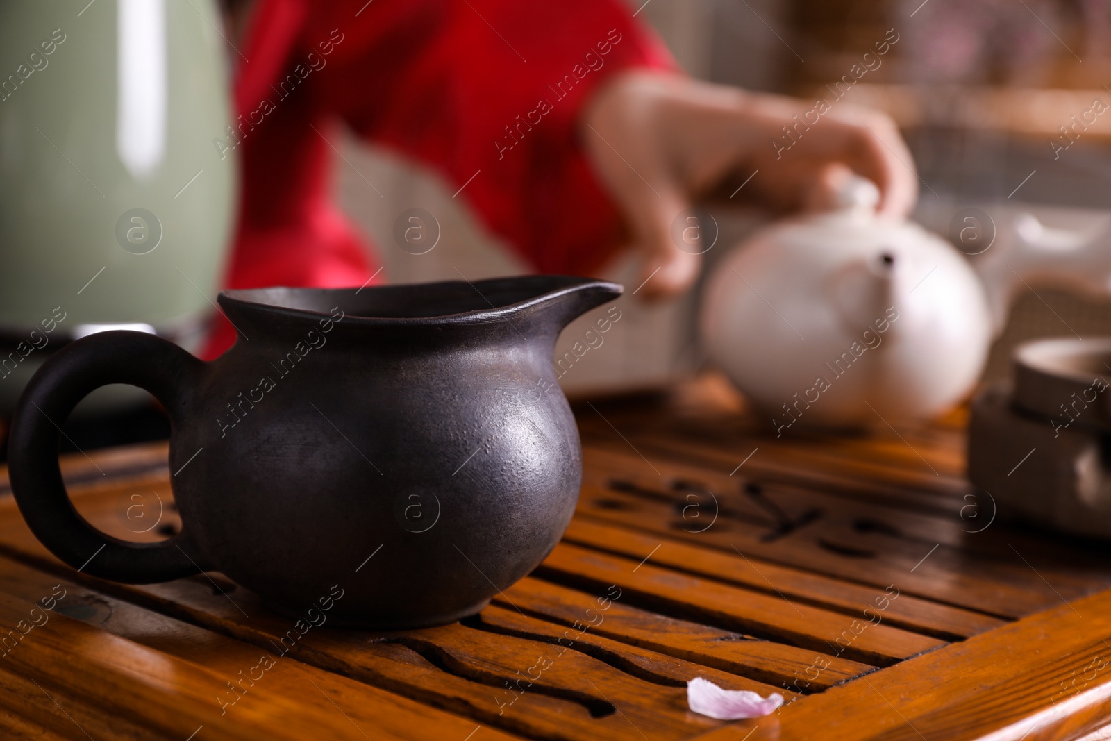 Photo of Traditional tea ceremony. Master near tray with tools, closeup