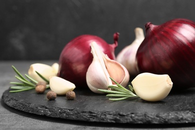 Photo of Composition with garlic and onion on slate plate