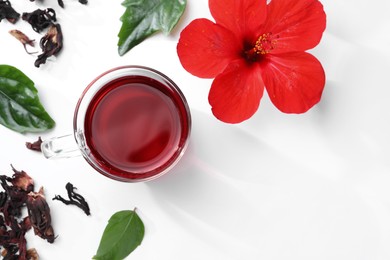 Flat lay composition with delicious hibiscus tea on white background, space for text