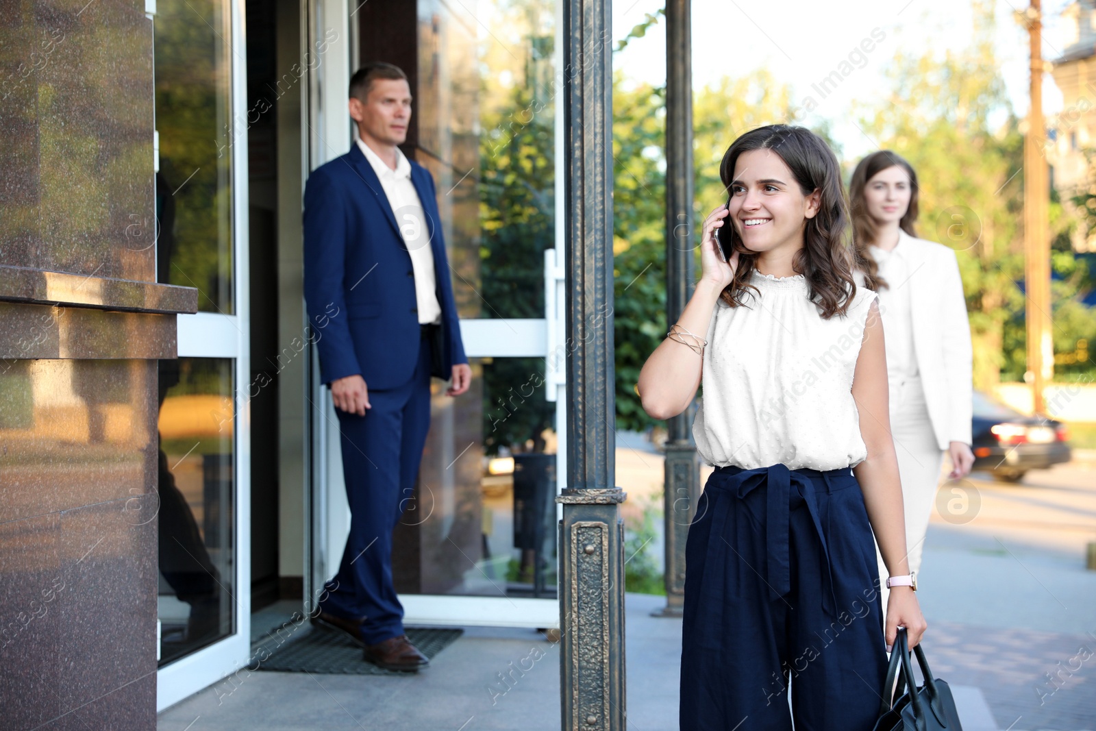 Photo of Different people walking on modern city street