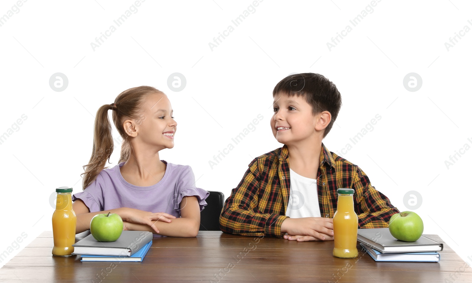 Photo of Happy children with healthy food for school lunch at desk on white background