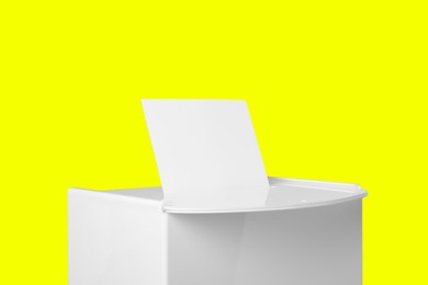 Ballot box with vote on yellow background. Election time
