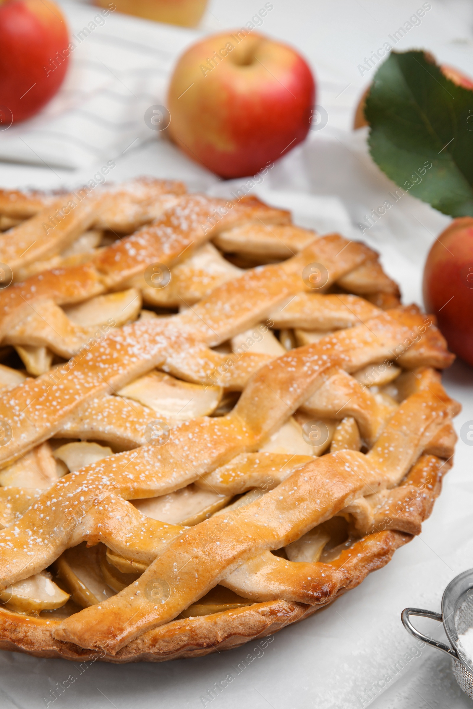 Photo of Delicious traditional apple pie on white table, closeup