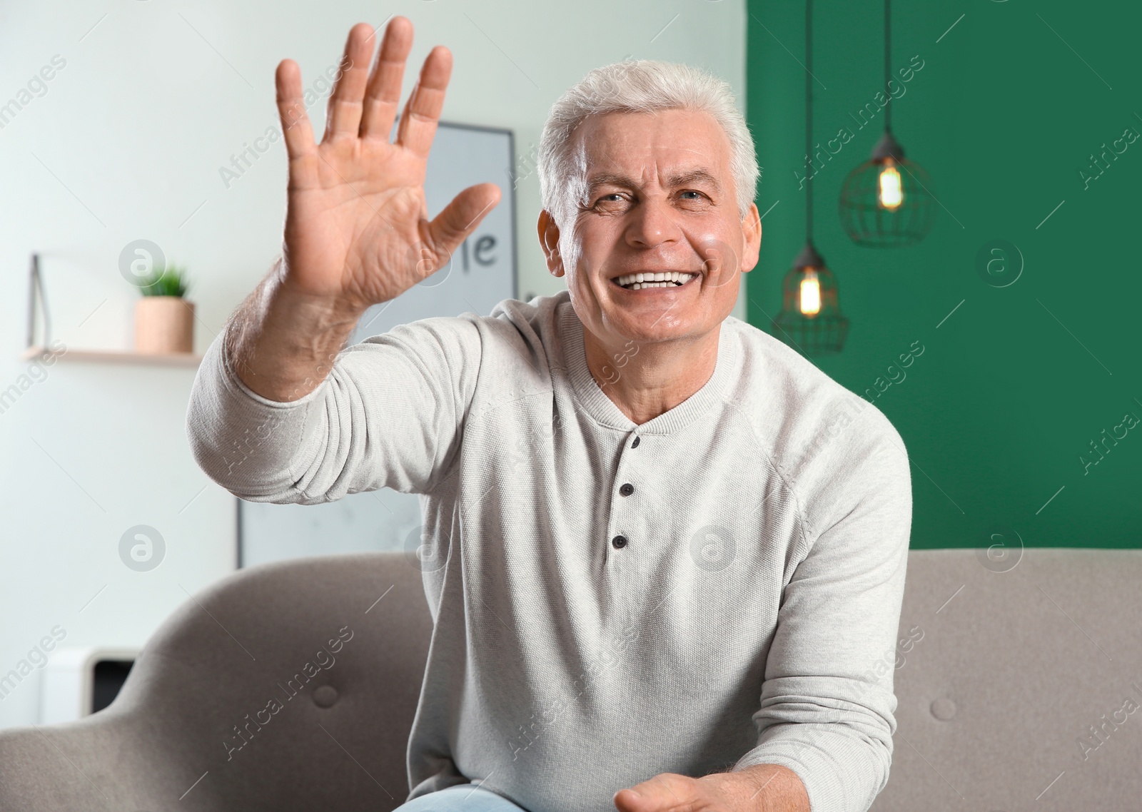 Photo of Mature man using video chat at home, view from web camera