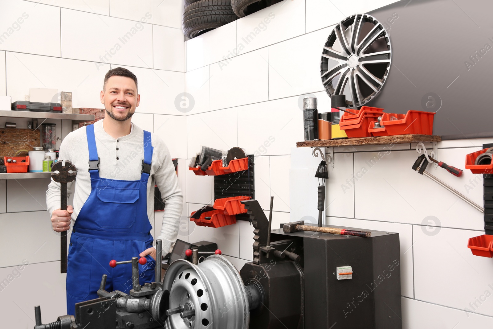 Photo of Mechanic near car disk lathe machine at tire service