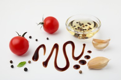 Photo of Organic balsamic vinegar and cooking ingredients on white background, flat lay