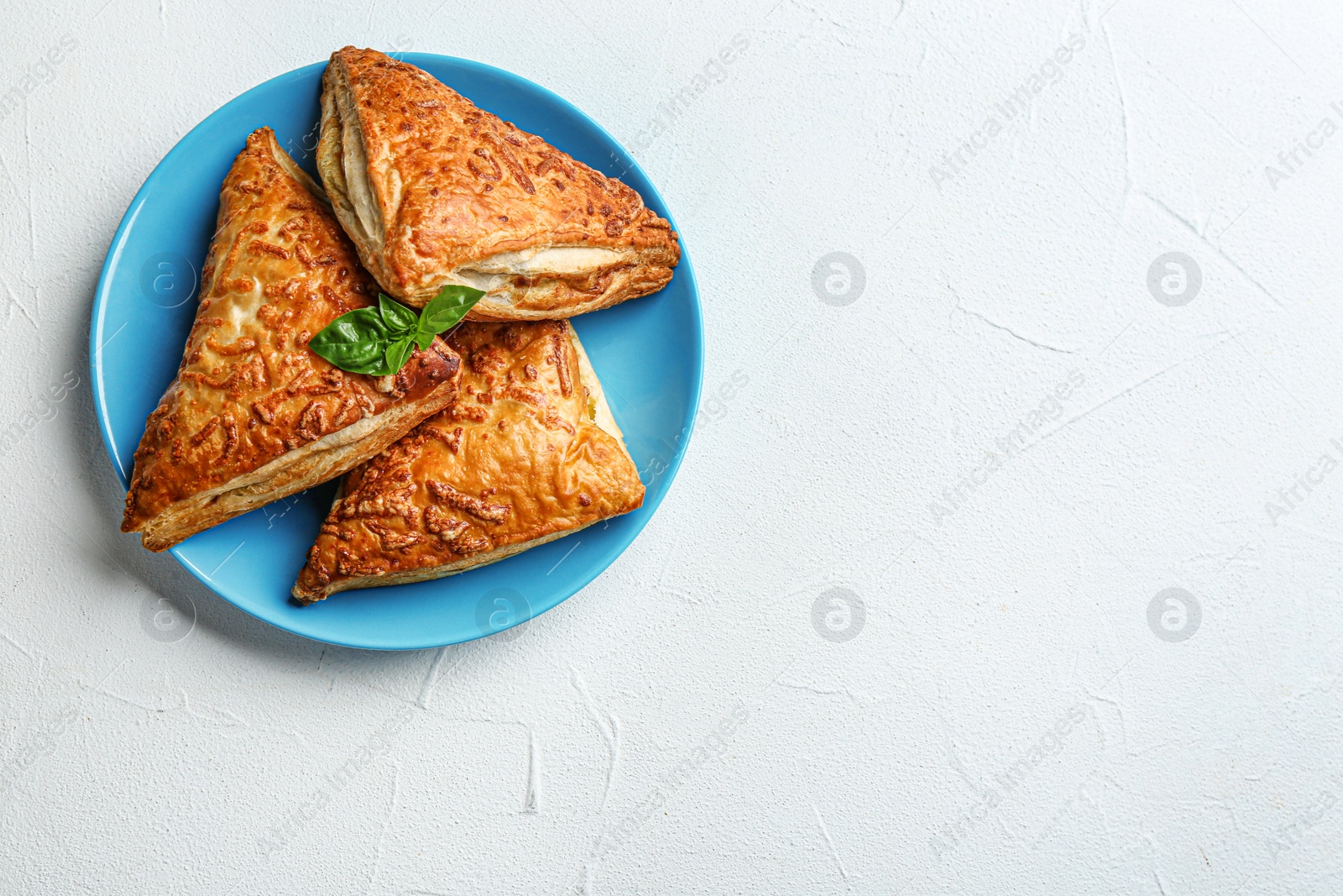 Photo of Fresh delicious puff pastry on grey table, top view. Space for text