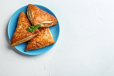 Fresh delicious puff pastry on grey table, top view. Space for text