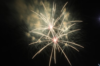 Photo of Beautiful fireworks lighting up night sky outdoors