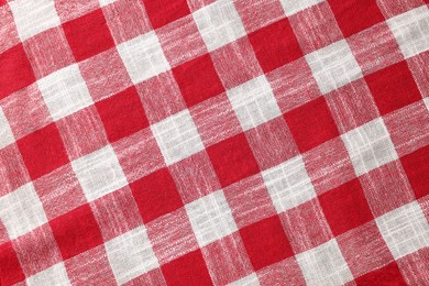 Red checkered tablecloth as background, top view