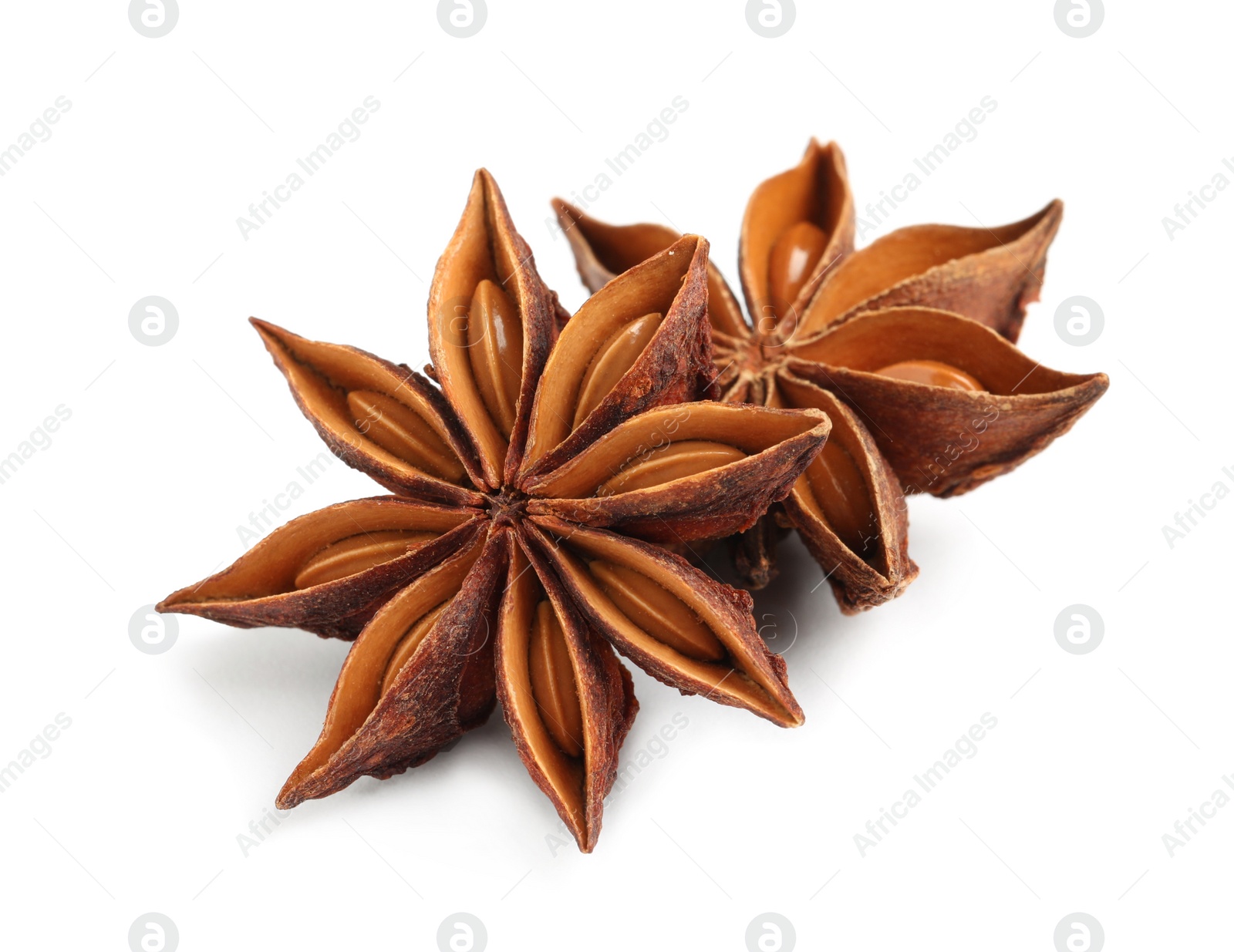 Photo of Dry anise stars with seeds on white background