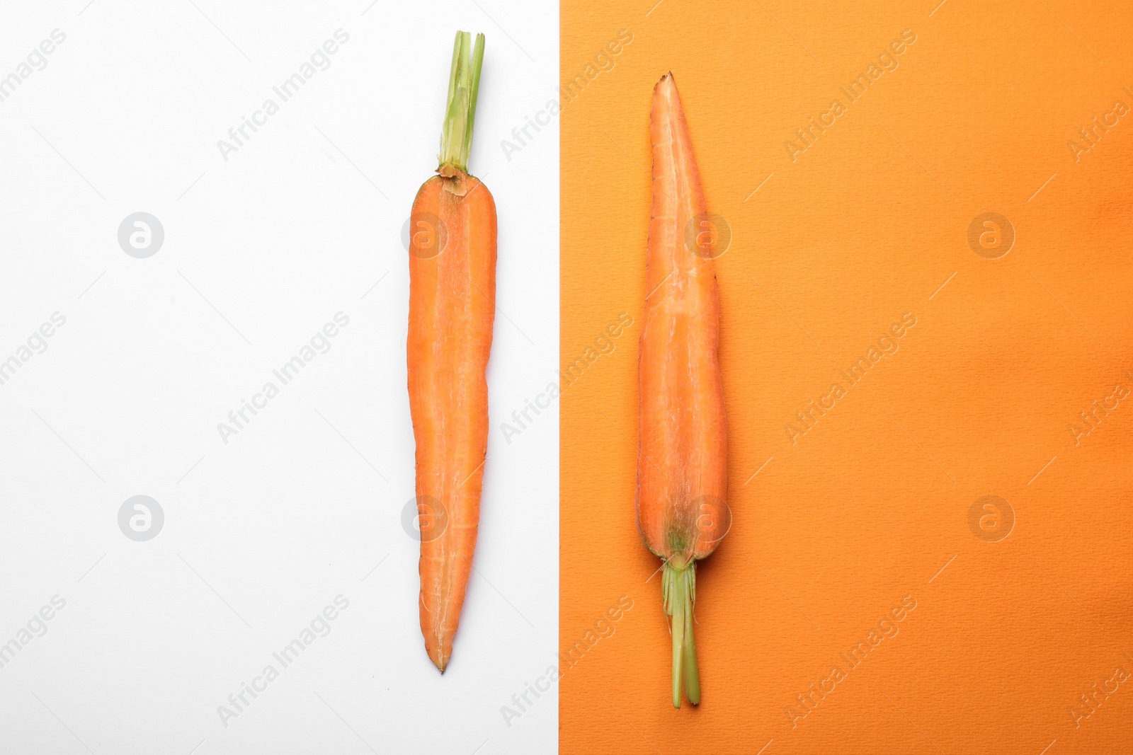 Photo of Flat lay composition with halves of fresh carrot on color background