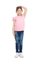 Little girl measuring her height on white background