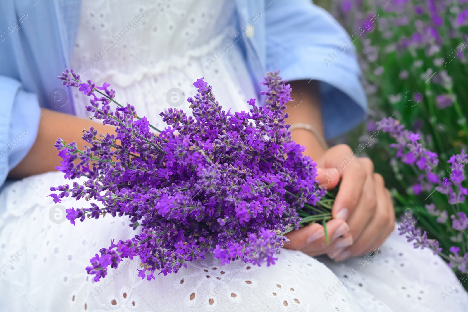 Photo of Woman with bouquet of beautiful lavender flowers outdoors, closeup