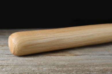 Photo of Baseball bat on wooden table. Sports equipment