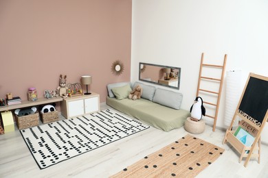 Photo of Montessori bedroom interior with floor bed and toys