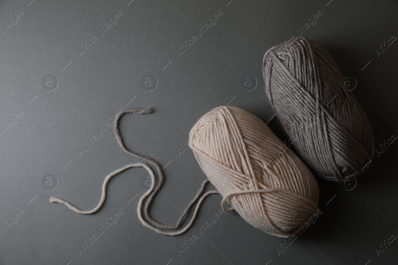 Photo of Soft colorful yarns for knitting on light grey background, top view