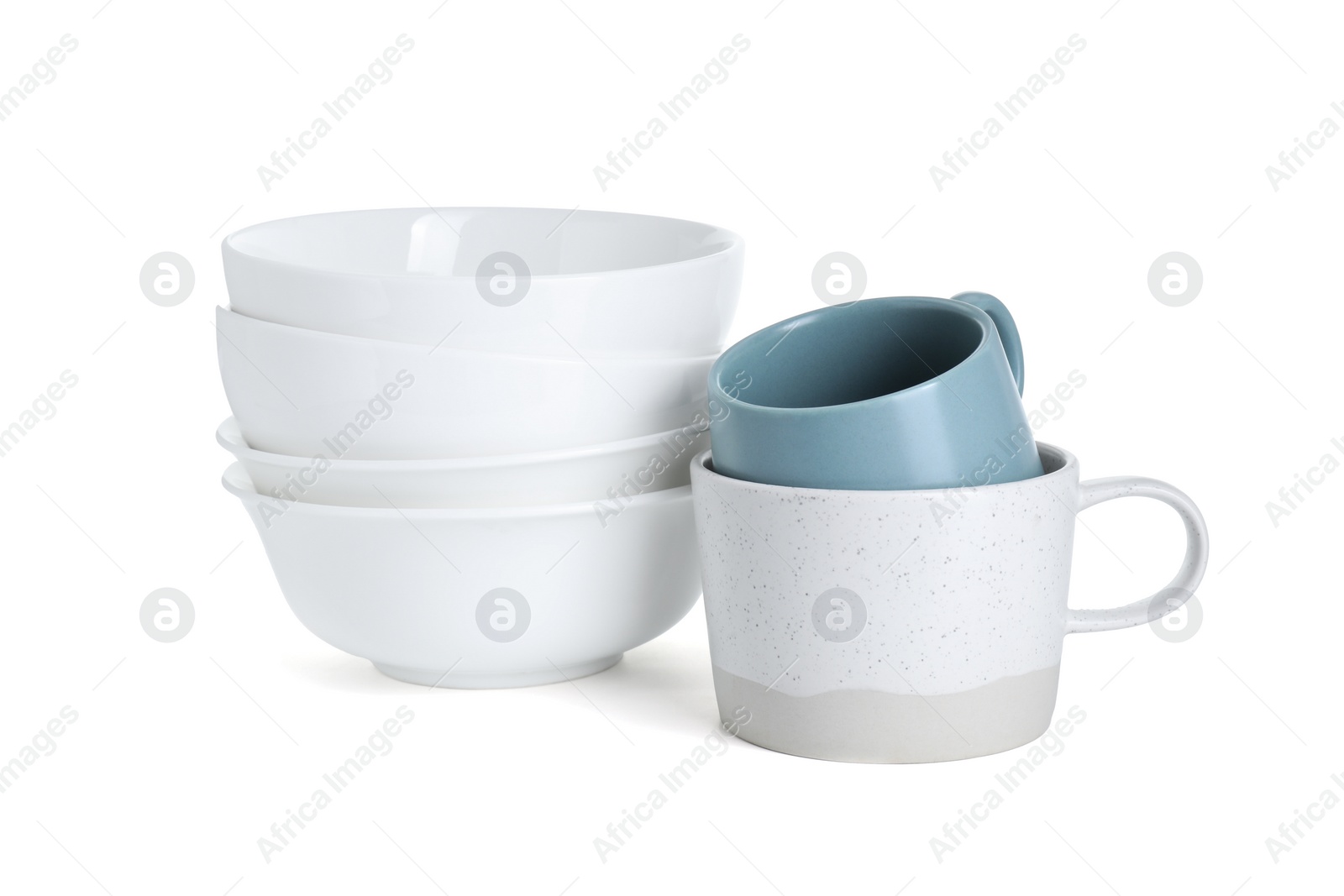 Photo of Beautiful ceramic bowls and cups isolated on white