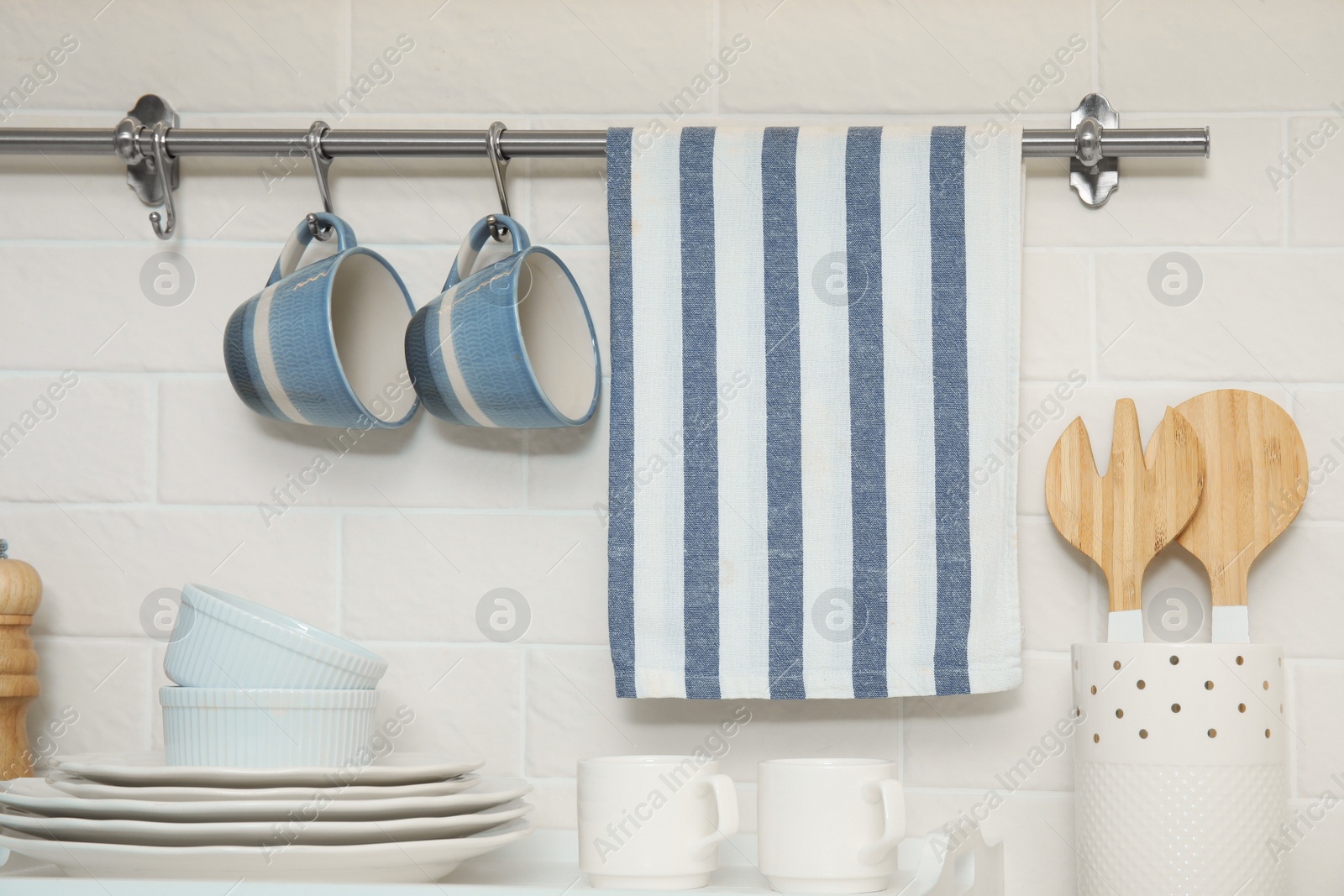 Photo of Clean towel, utensils and dishware in kitchen