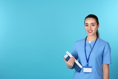 Photo of Young medical student with books on color background. Space for text