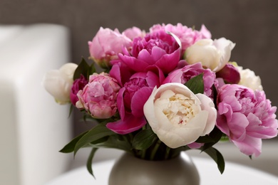 Photo of Bouquet of beautiful peonies in room, closeup