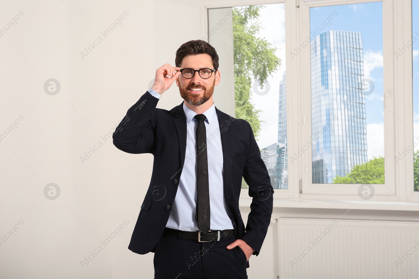 Photo of Handsome real estate agent in nice suit indoors