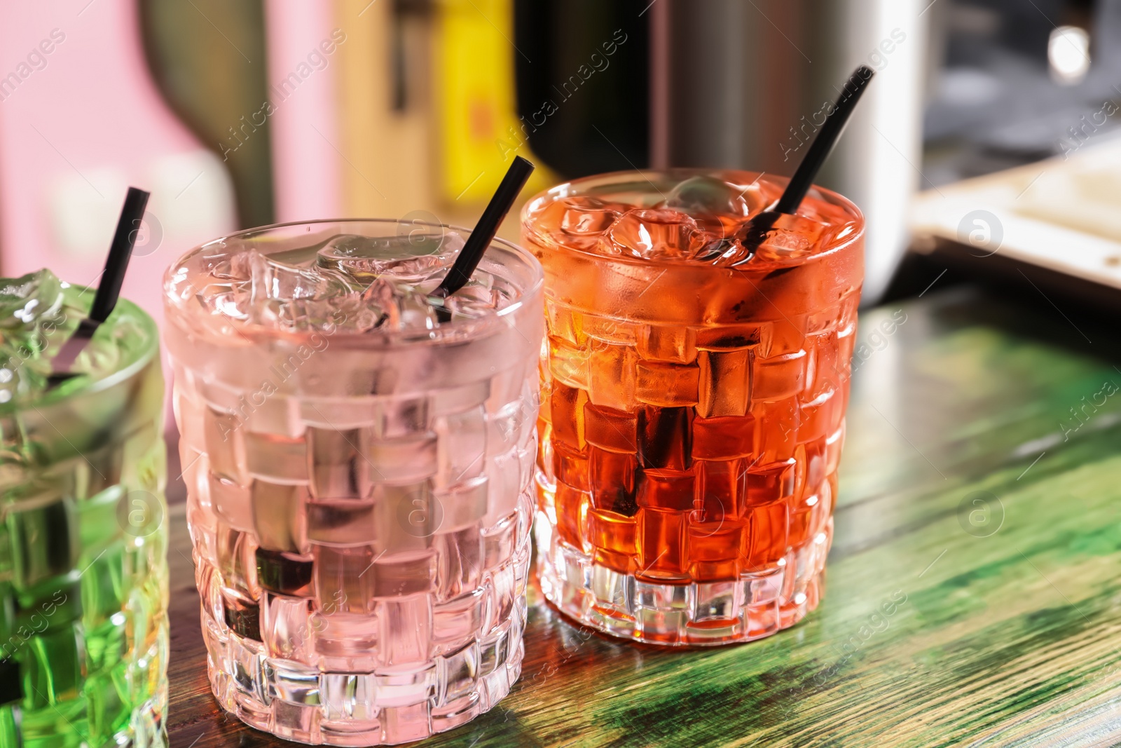 Photo of Glasses of delicious cocktails with ice on table, closeup