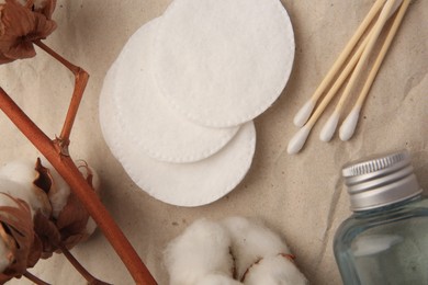 Flat lay composition with makeup remover and cotton flowers on crumpled paper