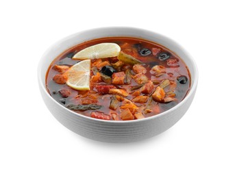 Photo of Meat solyanka soup with sausages, olives and vegetables in bowl isolated on white