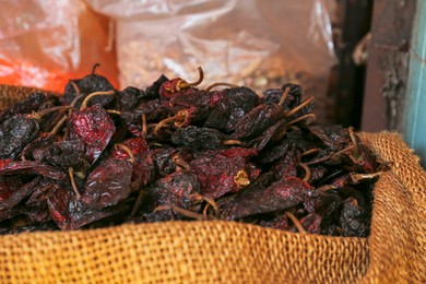Photo of Heap of Ancho chile peppers on counter at market, closeup