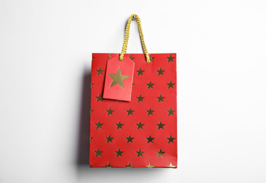 Photo of Red shopping paper bag with star pattern isolated on white