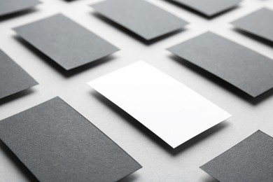 Blank business cards on light grey background, closeup. Mockup for design