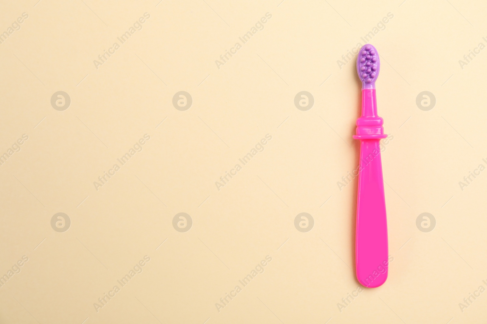 Photo of Manual toothbrush for child on color background, top view with space for text