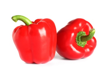 Tasty ripe red bell peppers on white background